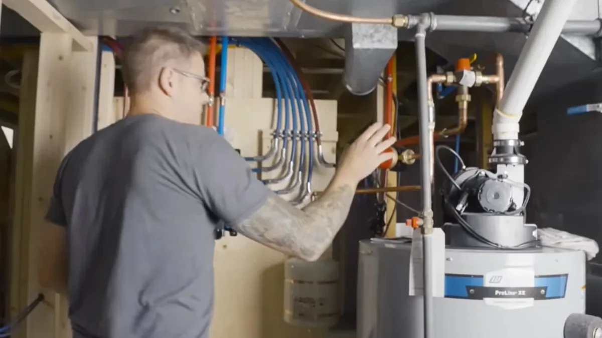 Plumber connecting supply lines on a new water heater